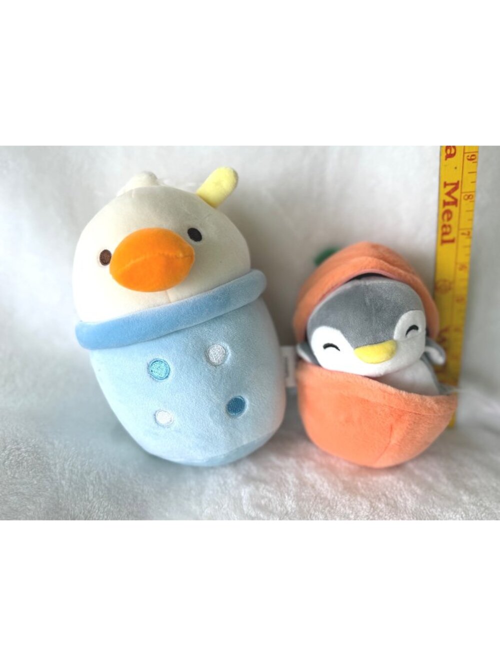 two Miniso plush duck milk tea & fruit mystery penguin zips in peach/orange
